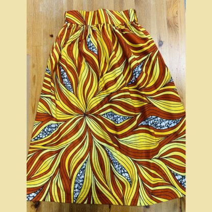 <span style="color: #ff6347; font-style: bold;">【売切】</span><br>099<br>アフリカ布の<br>スカート<br>オレンジ＆イエロー